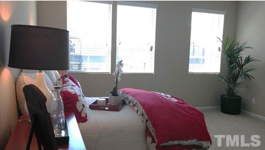 682 Wickham Ridge Road, Unit 145 Apex, NC 27539 - Photo 14 of 25 a living room with furniture and a flat screen tv
