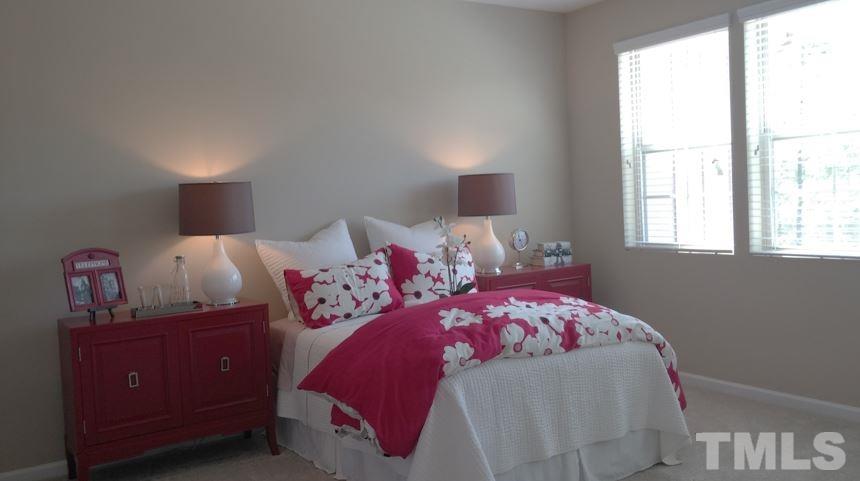 682 Wickham Ridge Road, Unit 145 Apex, NC 27539 - Photo 15 of 25 a bedroom with a bed and window
