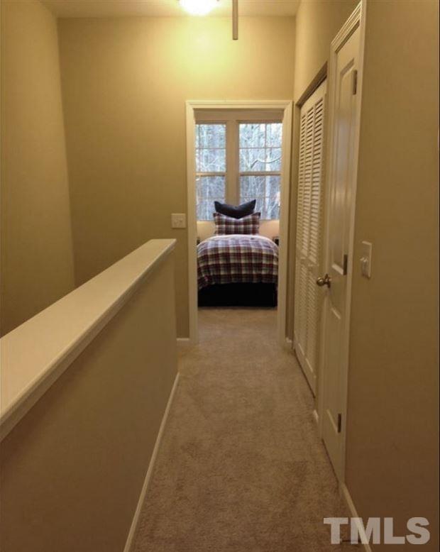 682 Wickham Ridge Road, Unit 145 Apex, NC 27539 - Photo 18 of 25 a bedroom with a bed and a window