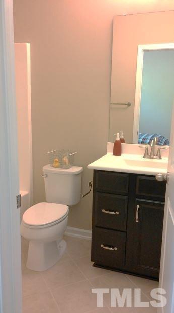 682 Wickham Ridge Road, Unit 145 Apex, NC 27539 - Photo 20 of 25 a bathroom with a sink and a toilet