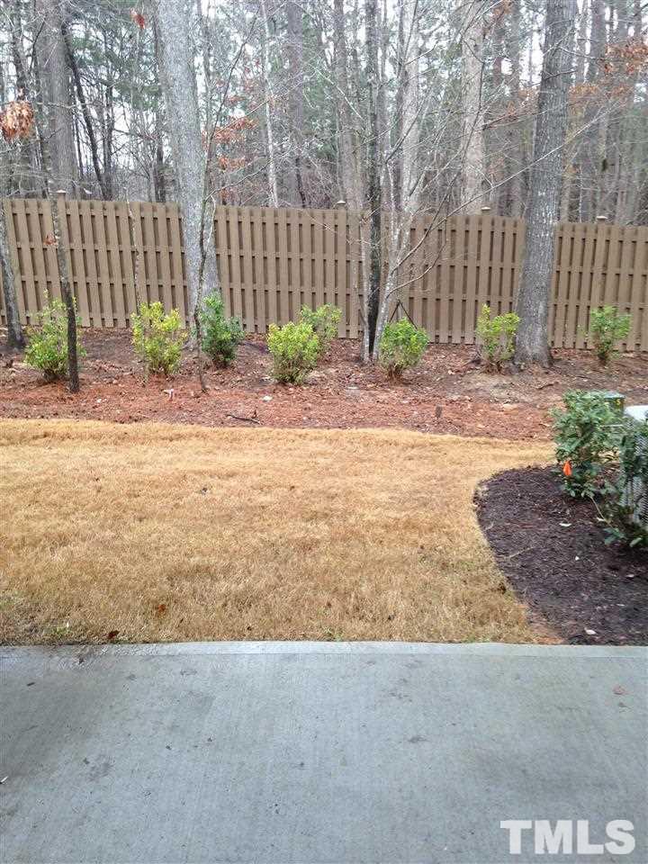 682 Wickham Ridge Road, Unit 145 Apex, NC 27539 - Photo 22 of 25 a view of a backyard of the house