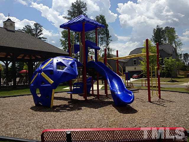 682 Wickham Ridge Road, Unit 145 Apex, NC 27539 - Photo 24 of 25 a view of a park with slide