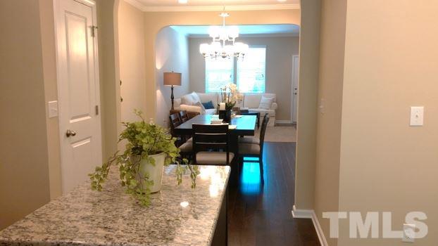 682 Wickham Ridge Road, Unit 145 Apex, NC 27539 - Photo 8 of 25 a room with a table and chairs in it