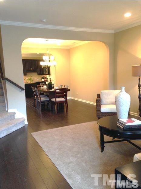682 Wickham Ridge Road, Unit 145 Apex, NC 27539 - Photo 9 of 25 a living room with dining room and large windows