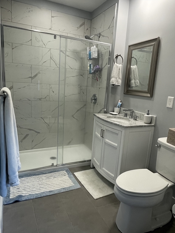 55 West Fifth Street, Unit 302 Boston, MA 02127 - Photo 3 of 7 a bathroom with a sink toilet and shower