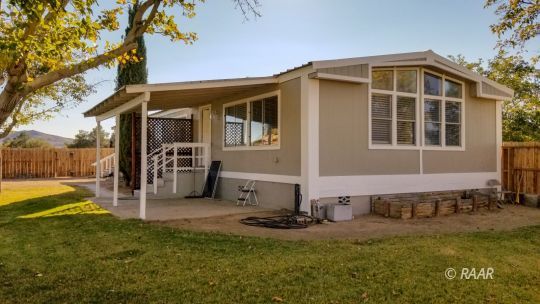 1441 West Perch Avenue Ridgecrest, CA 93555 - Photo 2 of 25 a front view of a house with a yard