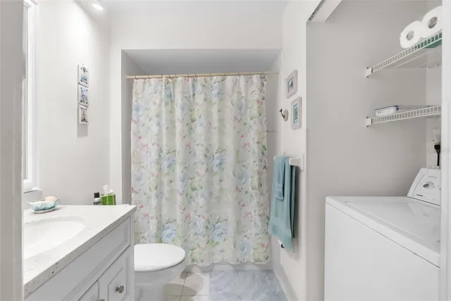 a view of a balcony with chair and wooden floor