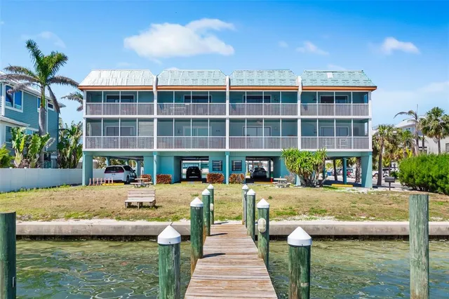 a view of a terrace with lawn chairs