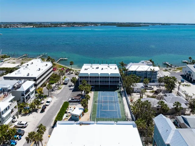an aerial view of a building with an outdoor space and seating