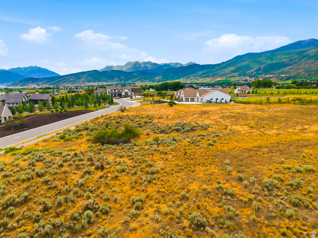 574 South Fox Den Road, Unit 3 Midway, UT 84049 - Photo 27 of 45 Expansive undeveloped lot featuring natural shrubbery and a clear sky, with mountain ranges forming the distant backdrop