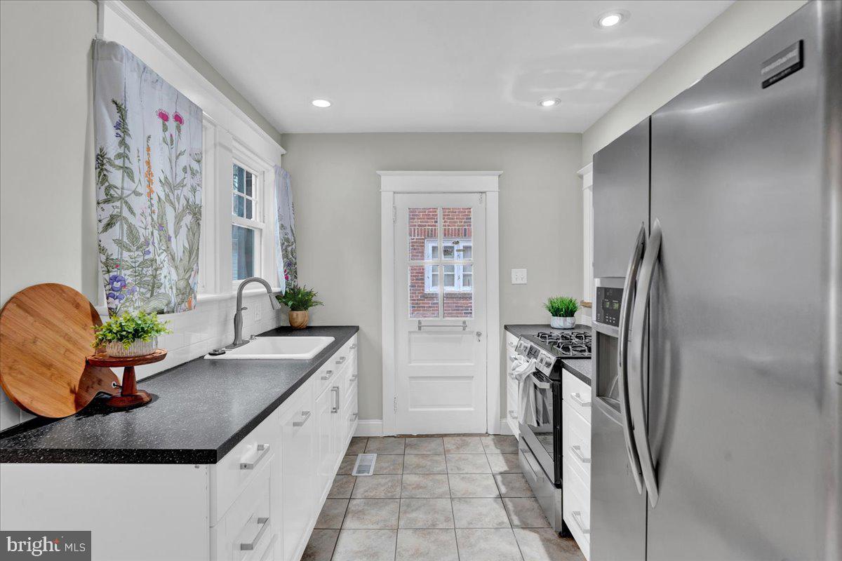 209 Hewett Road Wyncote, PA 19095 - Photo 12 of 36 a kitchen with stainless steel appliances granite countertop a refrigerator and a sink