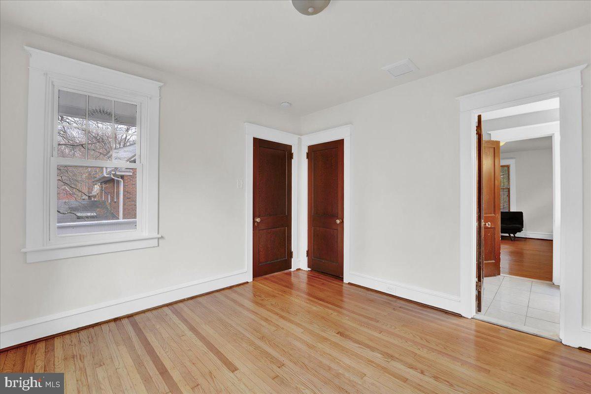 209 Hewett Road Wyncote, PA 19095 - Photo 20 of 36 a view of an empty room with wooden floor and a window