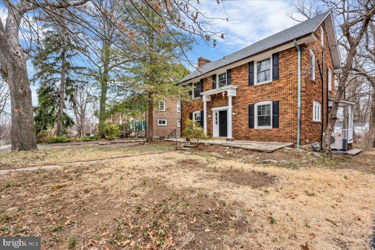 209 Hewett Road Wyncote, PA 19095 - Photo 2 of 36 a backyard of a house with large trees and outdoor seating