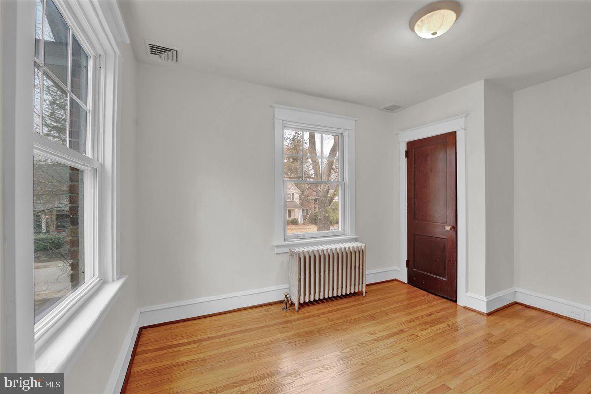 209 Hewett Road Wyncote, PA 19095 - Photo 23 of 36 an empty room with wooden floor and windows