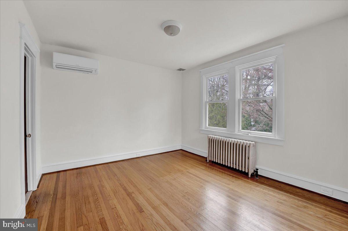 209 Hewett Road Wyncote, PA 19095 - Photo 26 of 36 a view of an empty room with wooden floor and a window