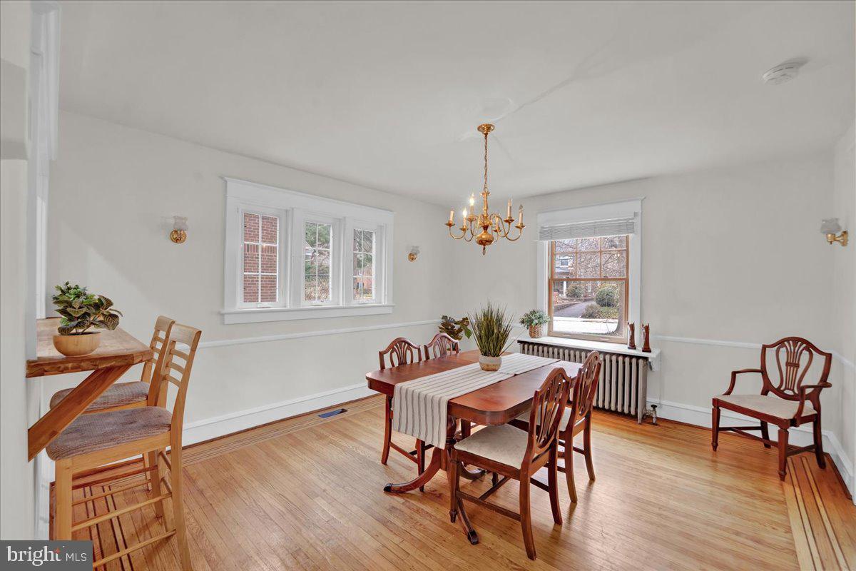 209 Hewett Road Wyncote, PA 19095 - Photo 8 of 36 a dining room with furniture a chandelier and wooden floor