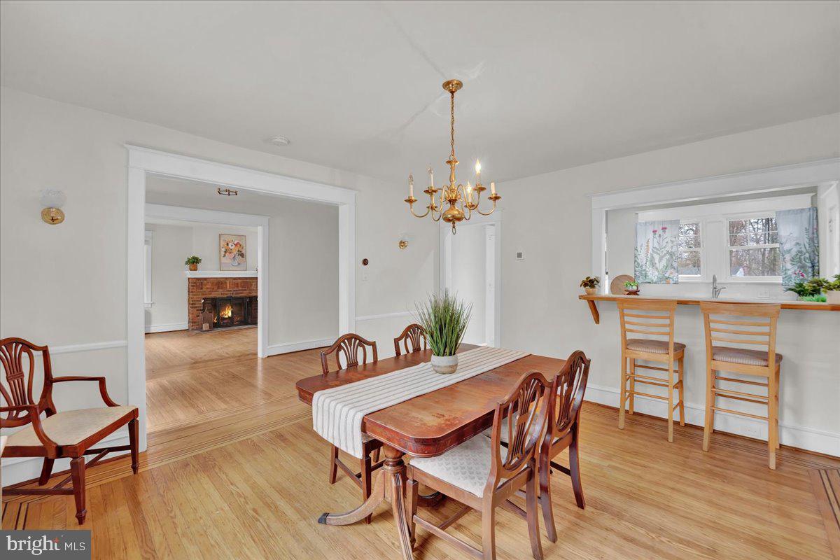 209 Hewett Road Wyncote, PA 19095 - Photo 9 of 36 a view of a dining room with furniture wooden floor and chandelier