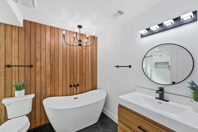 a bathroom with a toilet a sink and a mirror