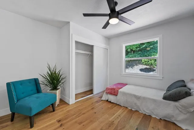 a bedroom with a bed plant and a window