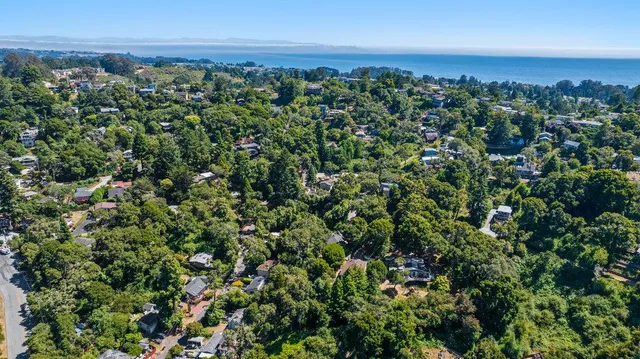 an aerial view of a houses with a yard
