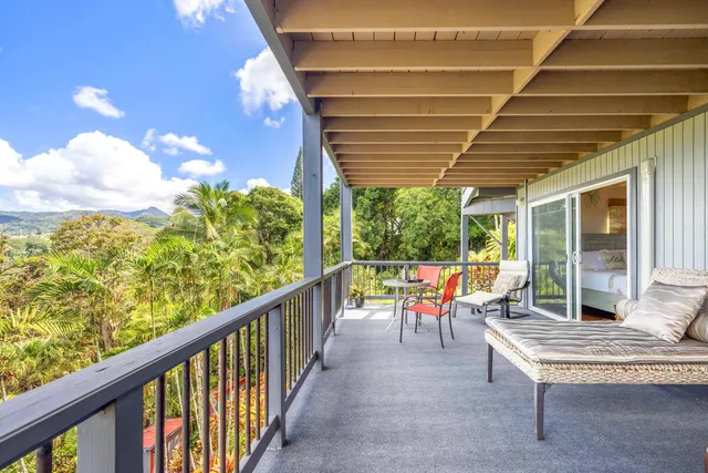 a view of a porch with furniture and a yard