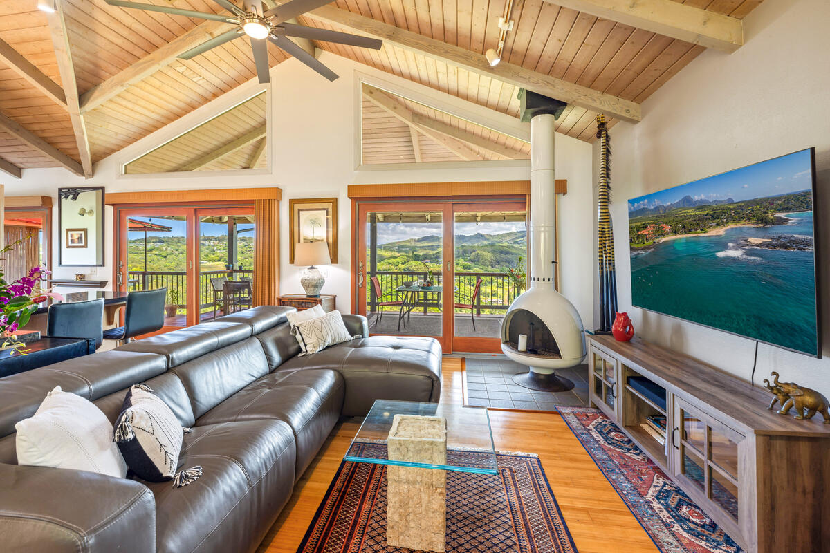 3307 D Hailima Road Koloa, HI 96756 - Photo 6 of 30 a living room with furniture a flat screen tv and floor to ceiling windows