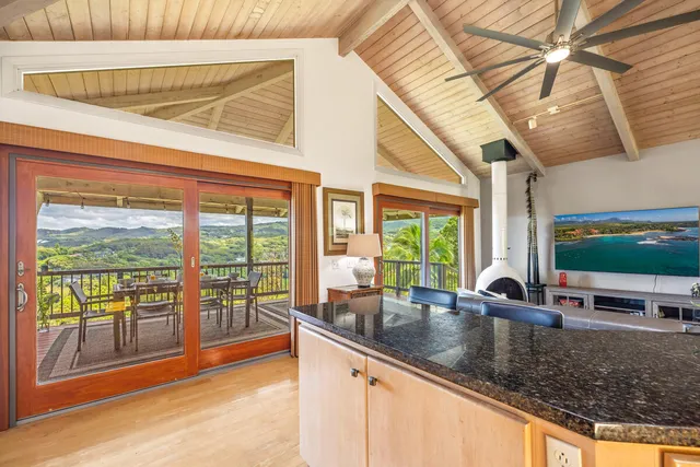 a kitchen view with a sink and large windows