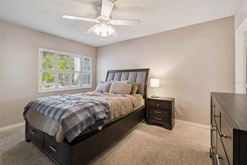 2618 Cedar View Court, Unit 95B Clearwater, FL 33761 - Photo 14 of 43 a bedroom with a bed and a chandelier