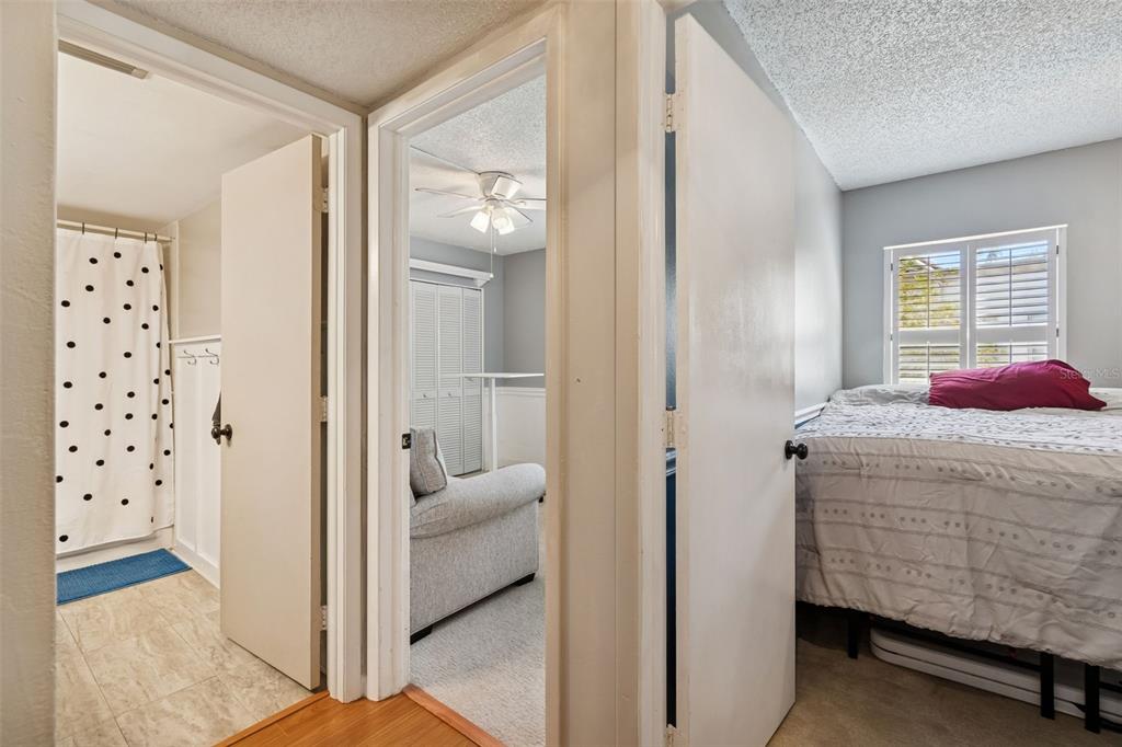 2618 Cedar View Court, Unit 95B Clearwater, FL 33761 - Photo 19 of 43 a bedroom with a bed and a view of bathroom