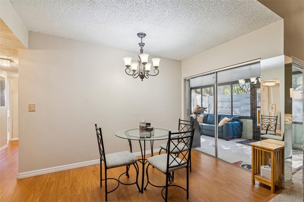 2618 Cedar View Court, Unit 95B Clearwater, FL 33761 - Photo 7 of 43 a view of a dining room with furniture wooden floor and chandelier