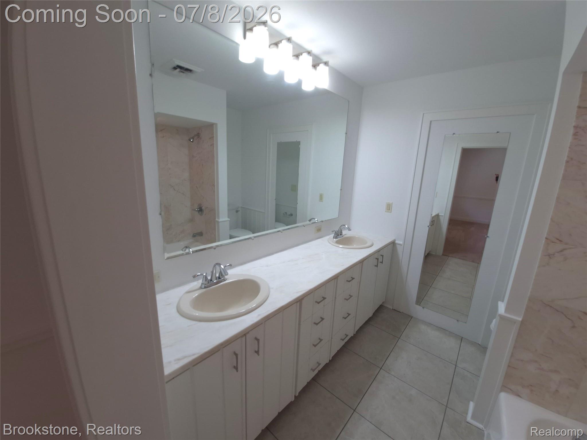 4140 South Henderson Road Davison, MI 48423 - Photo 65 of 98 Dual vanity with white cabinetry and light-toned countertops