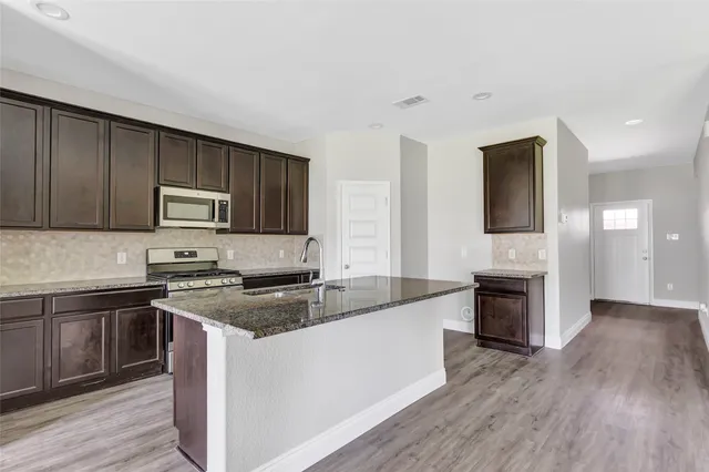 a view of kitchen with sink microwave and stove