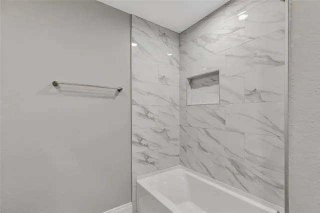 a bathroom with a granite countertop toilet and a sink