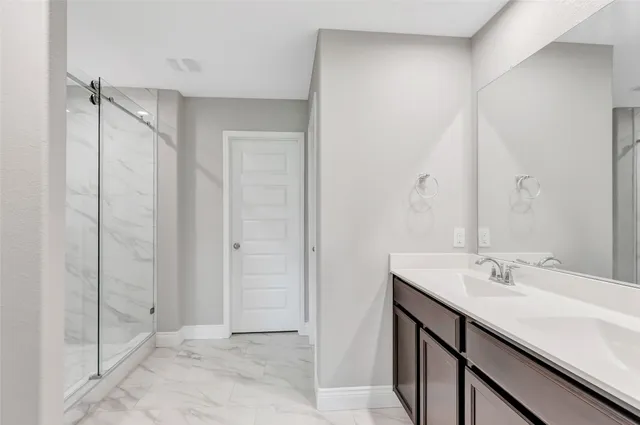 an empty room with wooden floor and ceiling fan