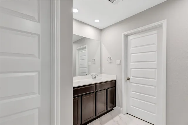 a bathroom with a shower and a glass door