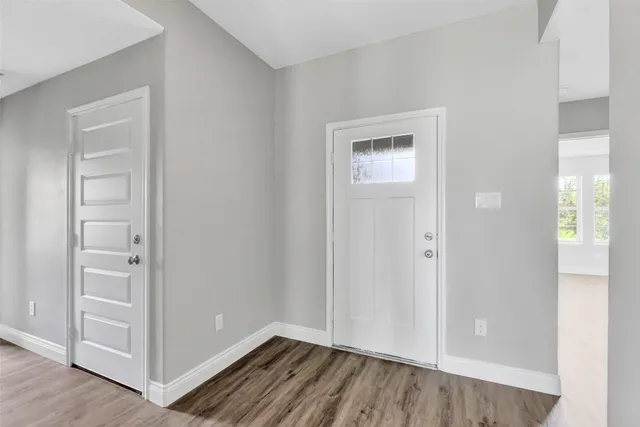 an empty room with closet and wooden floor