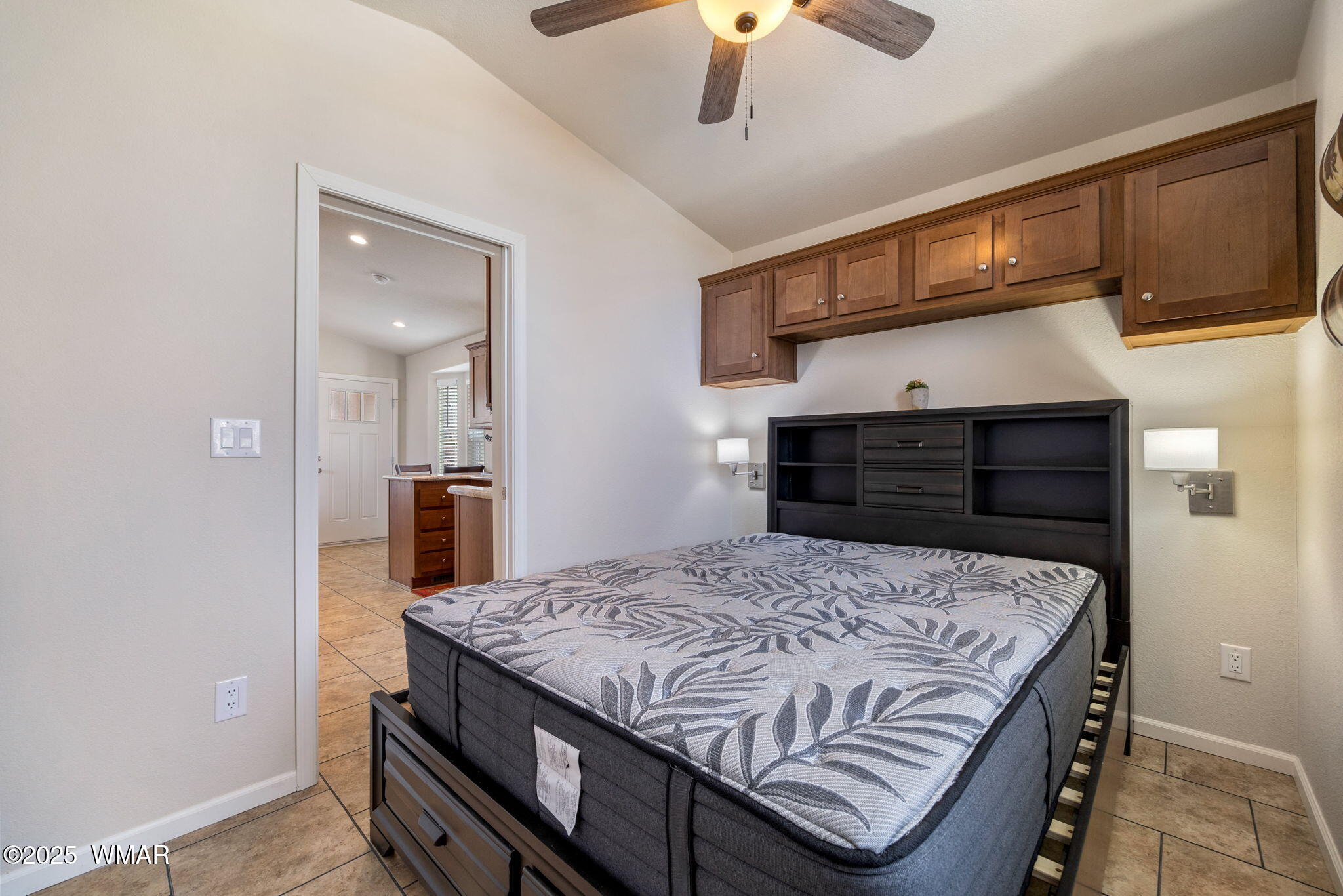 2206 Wrangler Way Overgaard, AZ 85933 - Photo 15 of 38 a bedroom with a bed and a chandelier