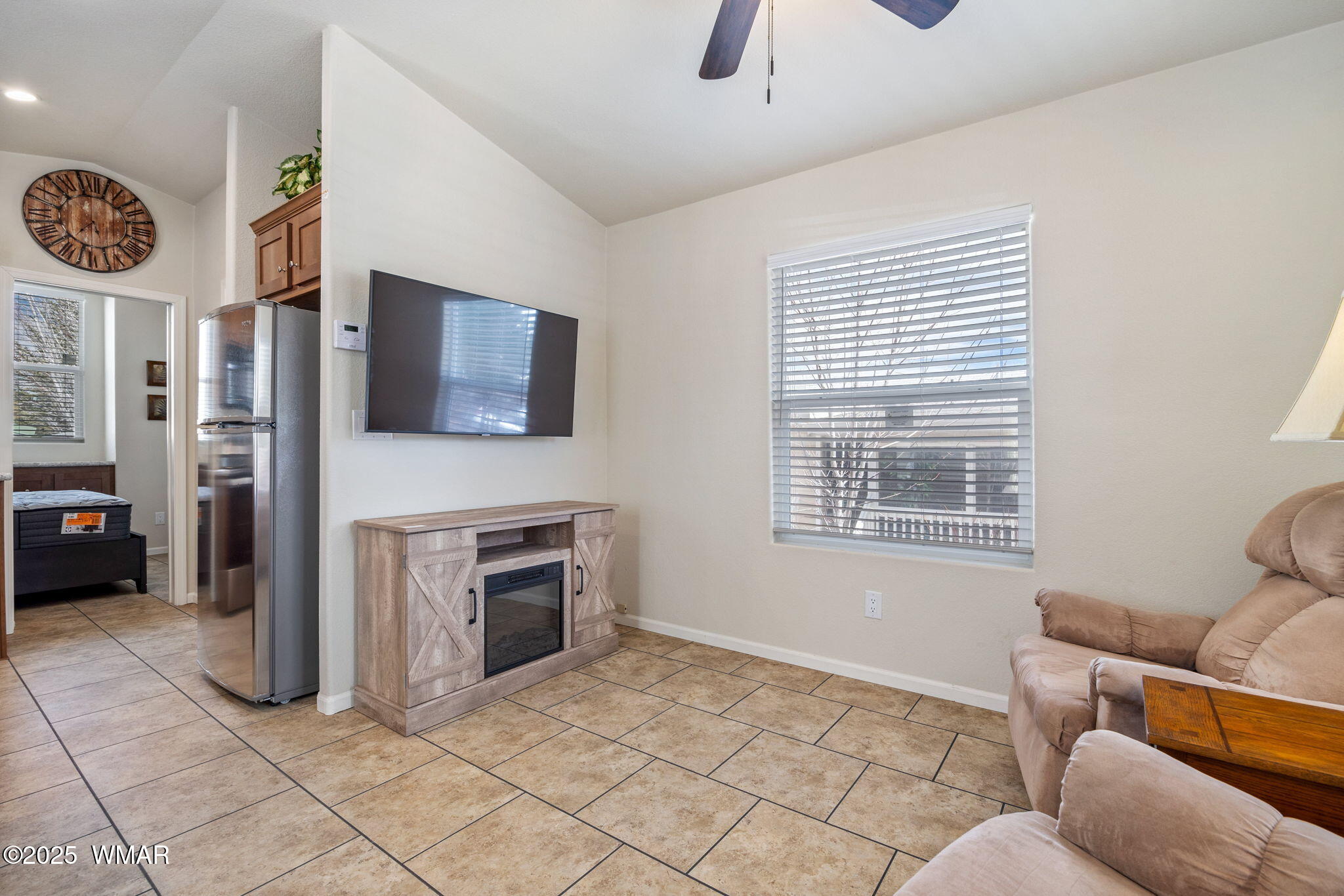 2206 Wrangler Way Overgaard, AZ 85933 - Photo 8 of 38 a living room with furniture a flat screen tv and a fireplace