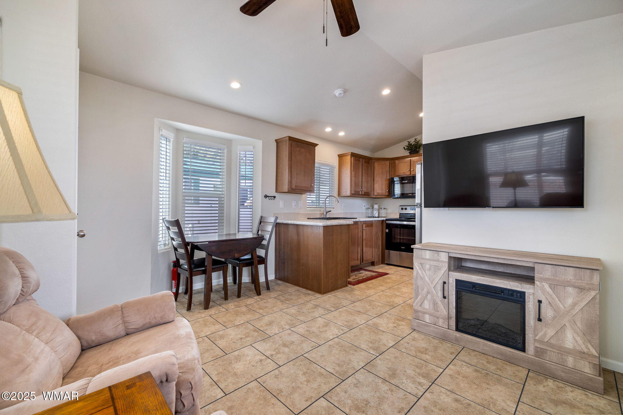 2206 Wrangler Way Overgaard, AZ 85933 - Photo 10 of 38 a living room with stainless steel appliances furniture a fireplace and a flat screen tv