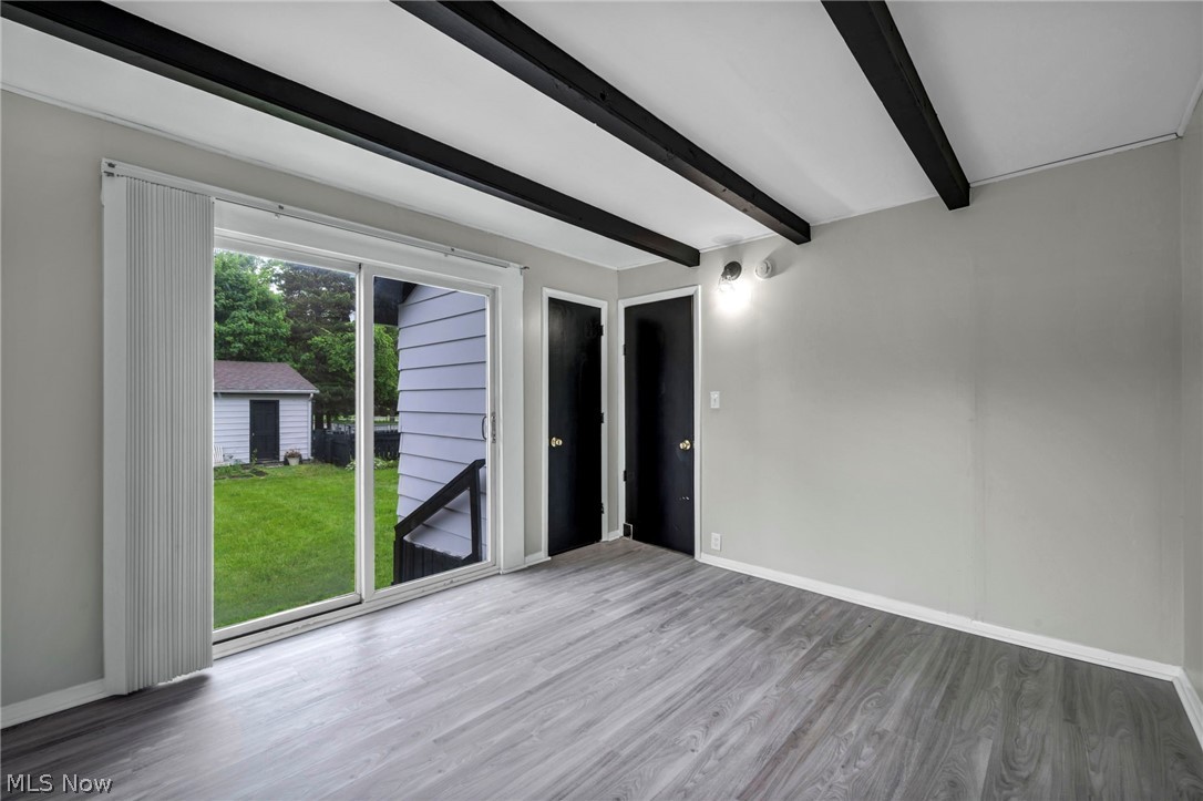 1603 Winchester Road Lyndhurst, OH 44124 - Photo 19 of 34 First floor bedroom with a sliding door leading directly to the backyard, offering easy indoor-outdoor access and added natural light.