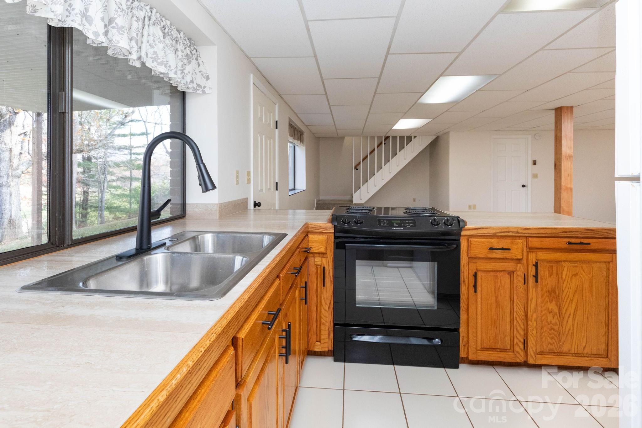 84 Joe Jenkins Road Fairview, NC 28730 - Photo 17 of 26 a kitchen with granite countertop a sink and a stove