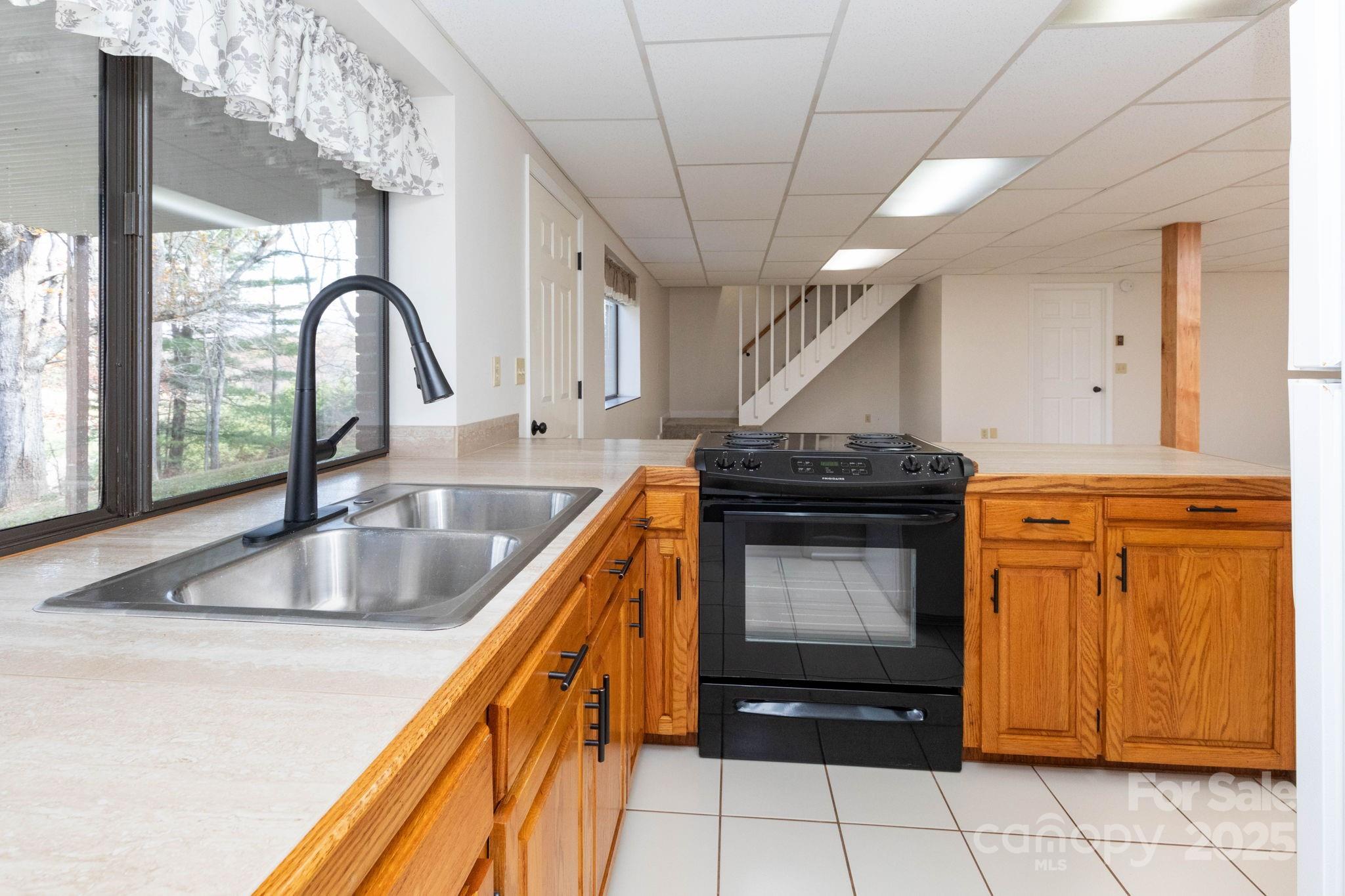 84 Joe Jenkins Road Fairview, NC 28730 - Photo 17 of 26 a kitchen with granite countertop a sink and a stove