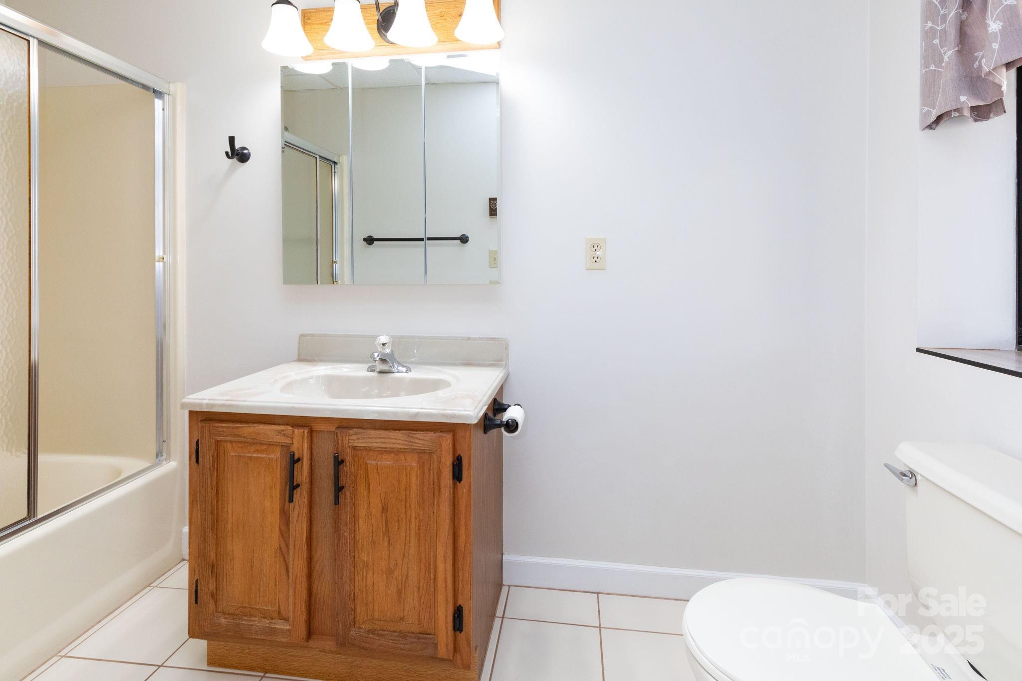 84 Joe Jenkins Road Fairview, NC 28730 - Photo 22 of 26 a bathroom with a sink a toilet and shower