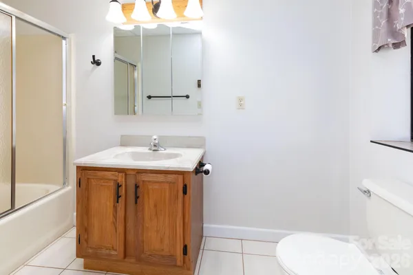 a bathroom with a double vanity sink toilet and shower