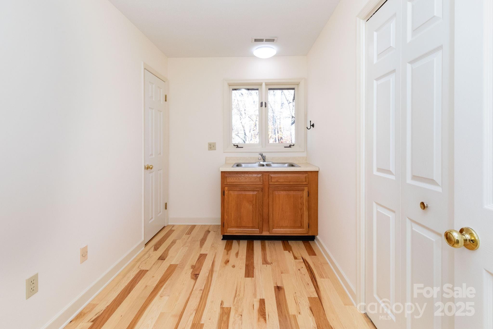 84 Joe Jenkins Road Fairview, NC 28730 - Photo 23 of 26 a room with a sink and wooden floor