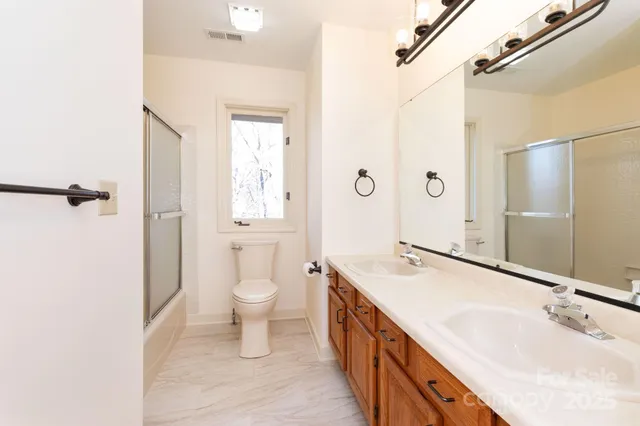 a spacious bathroom with a tub sink and mirror