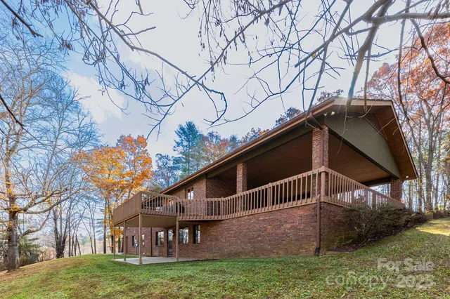a brick building with a big yard and large trees
