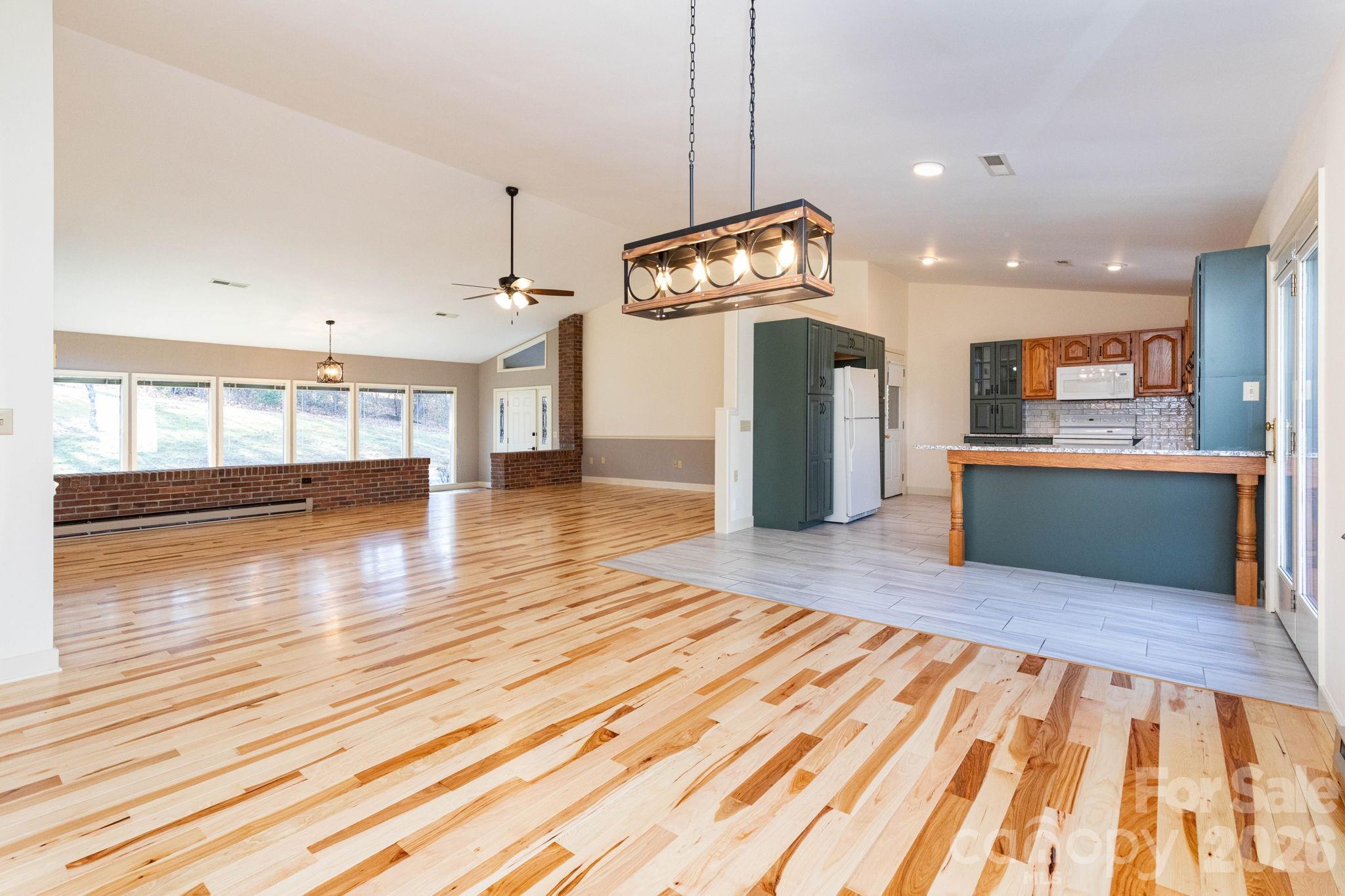 84 Joe Jenkins Road Fairview, NC 28730 - Photo 8 of 26 a view of kitchen and hall with wooden floor