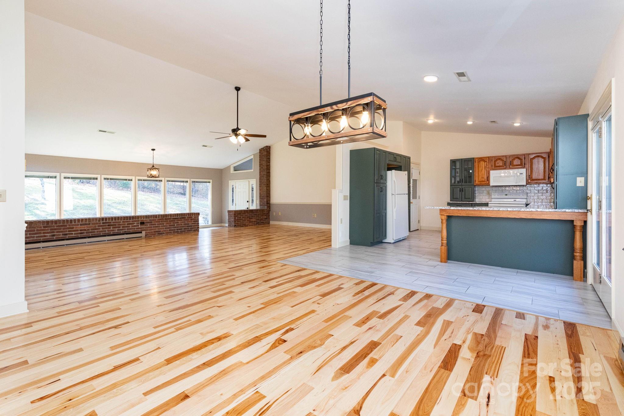 84 Joe Jenkins Road Fairview, NC 28730 - Photo 8 of 26 a view of kitchen and hall with wooden floor