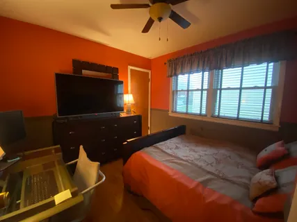 a bedroom with a bed and a flat screen tv